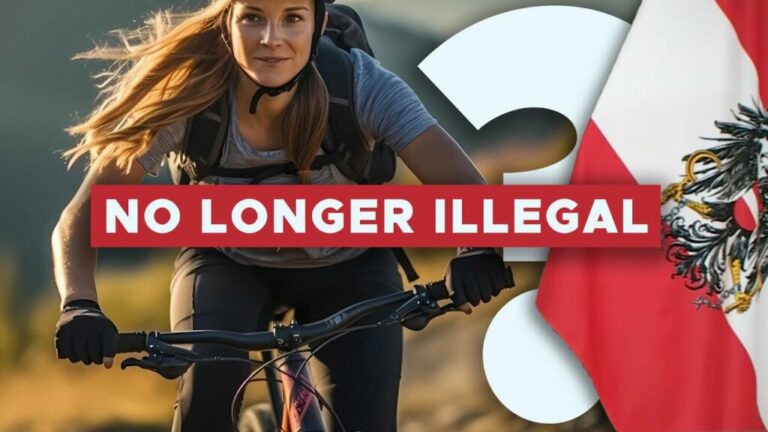 Mountain biking in Austria: rider on a trail with the Austrian flag and the words no longer illegal